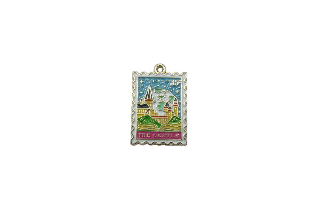 Enamel postage stamp with castle scene and “THE CASTLE” text