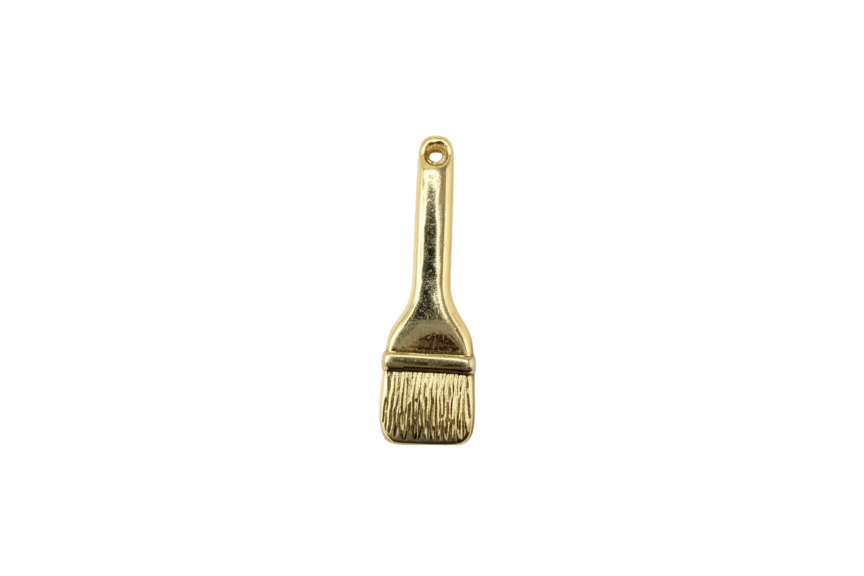 Gold paintbrush charm with textured bristles