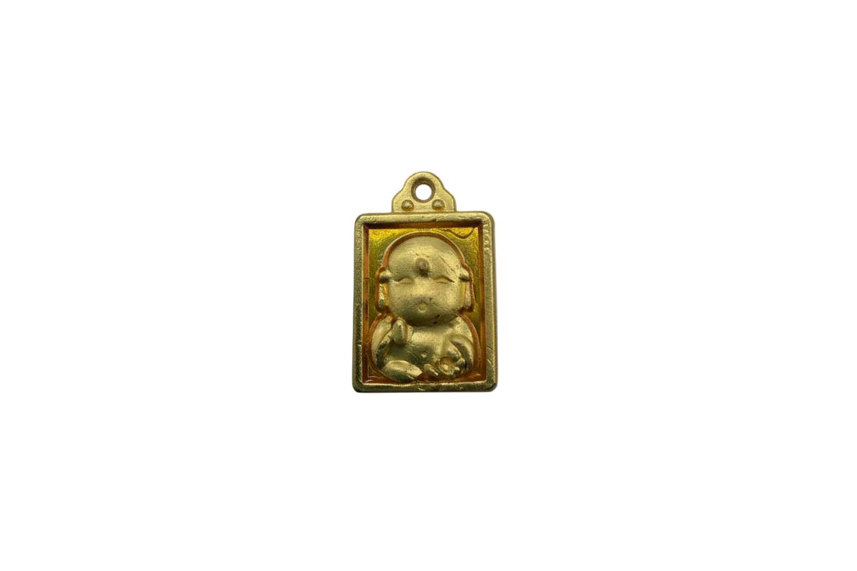 Gold plaque with raised seated baby and amber-toned background