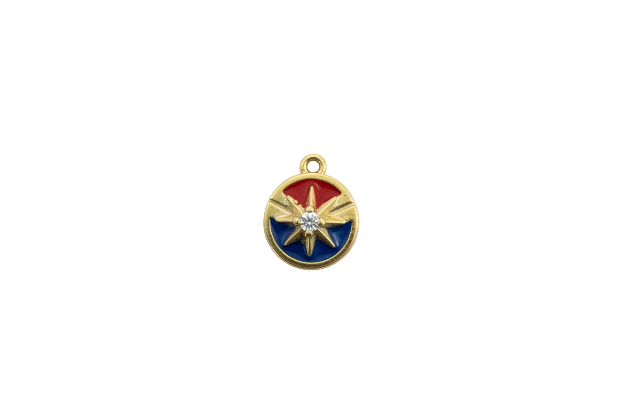 Gold compass rose medallion with red/blue enamel and clear gem