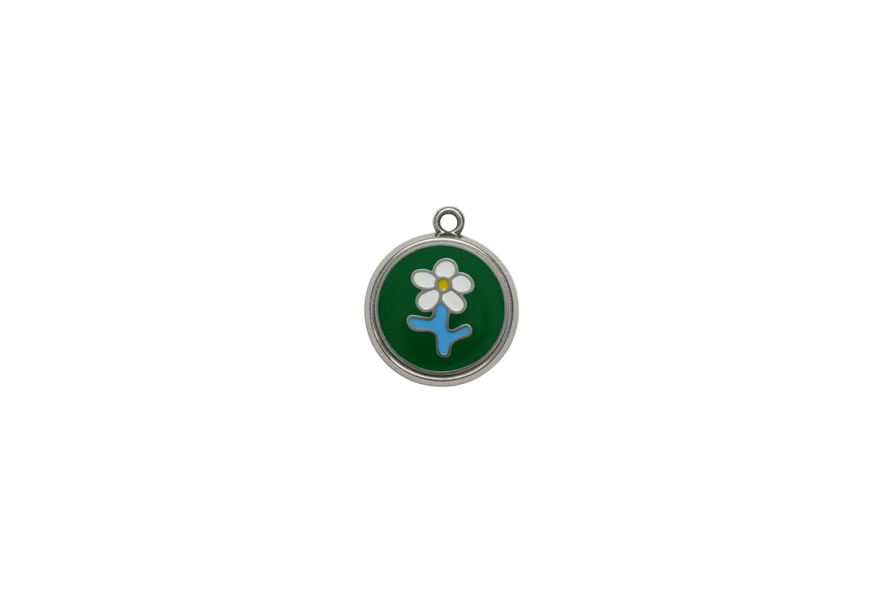 Silver medallion with green enamel and white flower motif