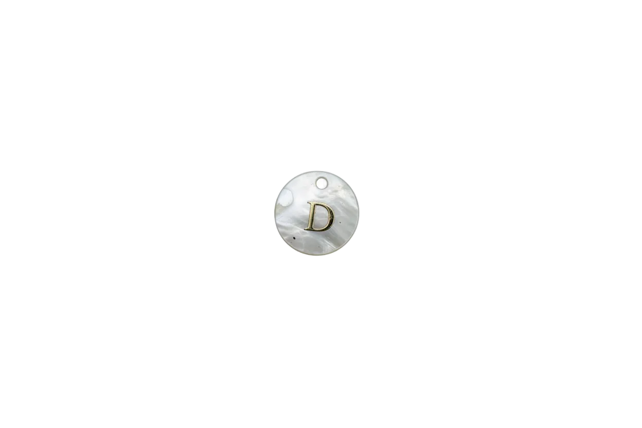 Mother-of-pearl disc with raised gold letter D