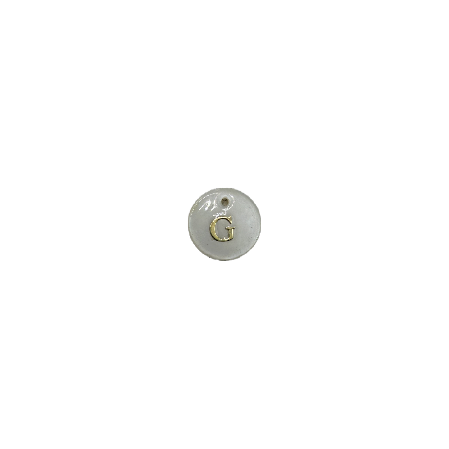White disc with raised gold letter G