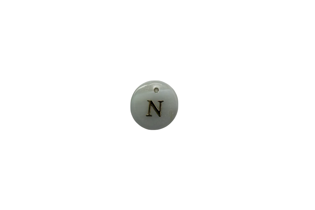 White round disc with gold serif letter N