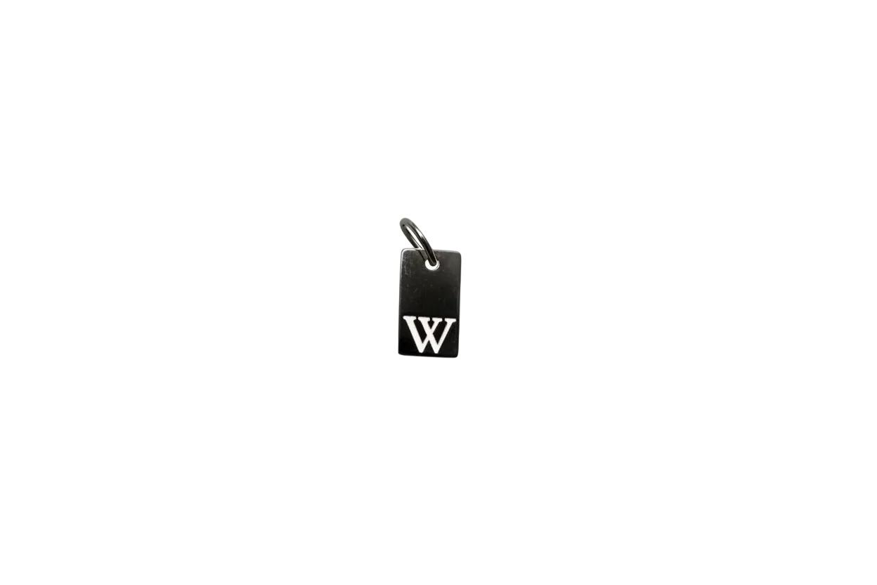 Black rectangular tag with raised silver interlocking initials