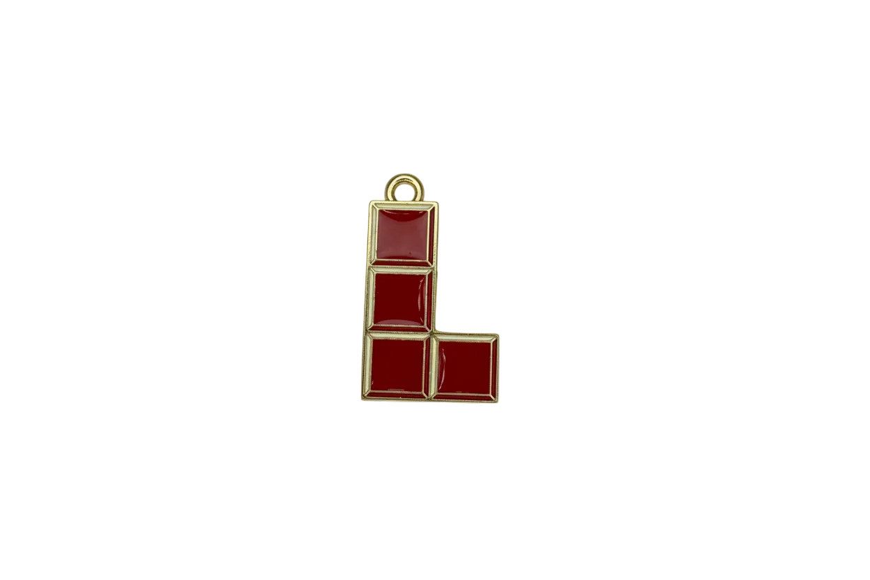 Red enamel L-shaped block puzzle piece with gold outline