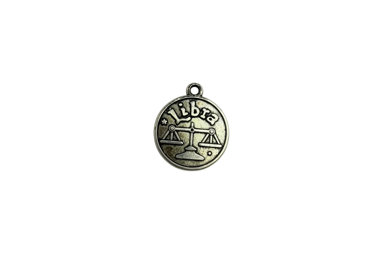 Antique silver Libra zodiac coin with scales and "Libra" text