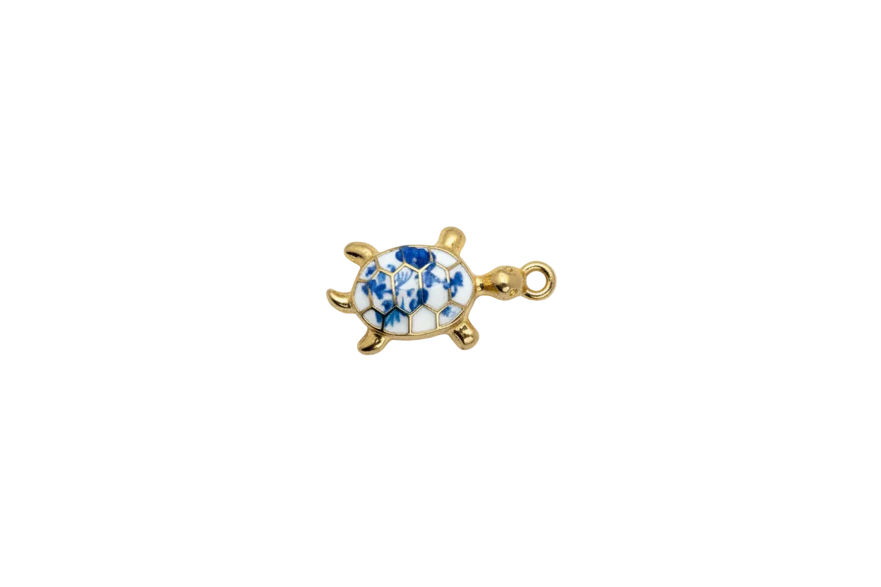 Gold sea turtle with blue floral white shell