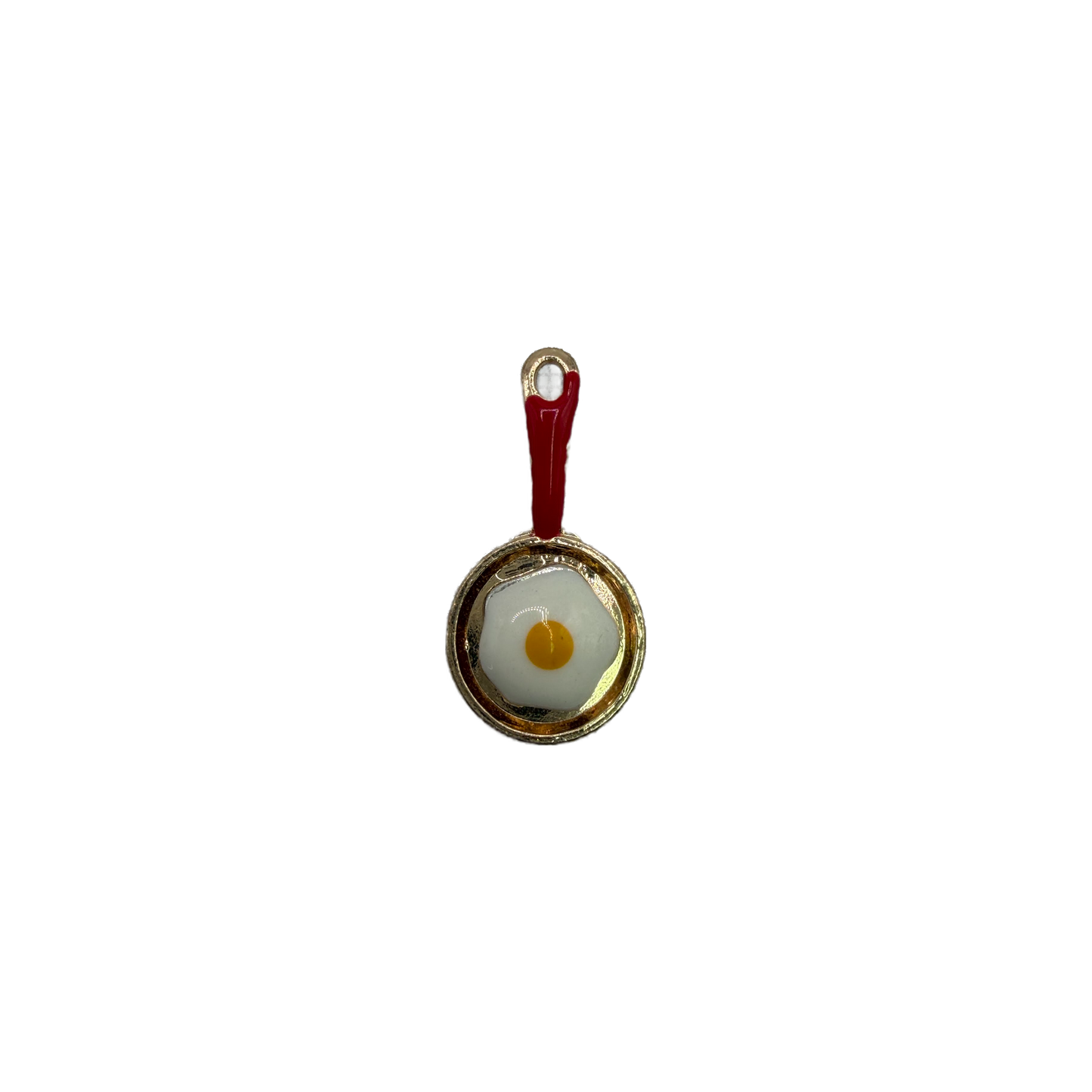 Gold skillet with red handle and sunny-side-up egg