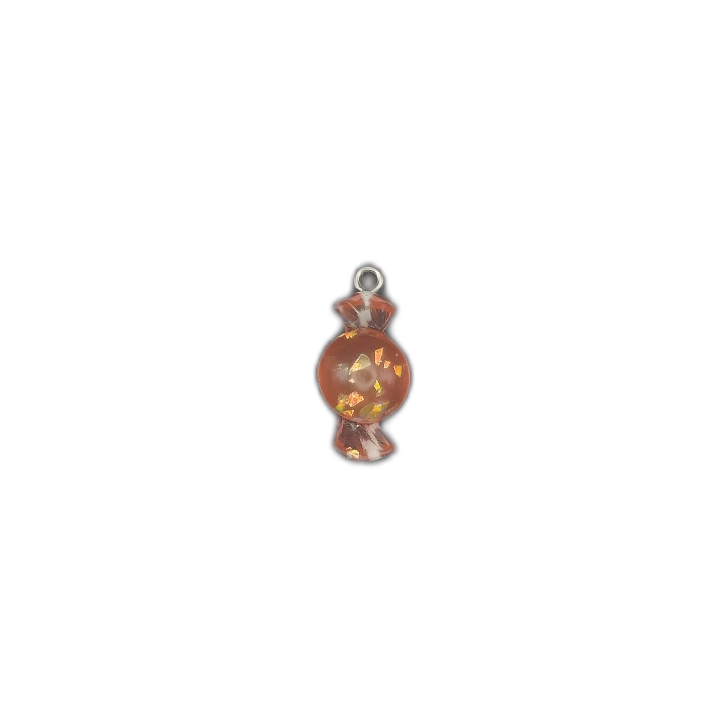 small orange candy-shaped charm with iridescent flakes centered on black background