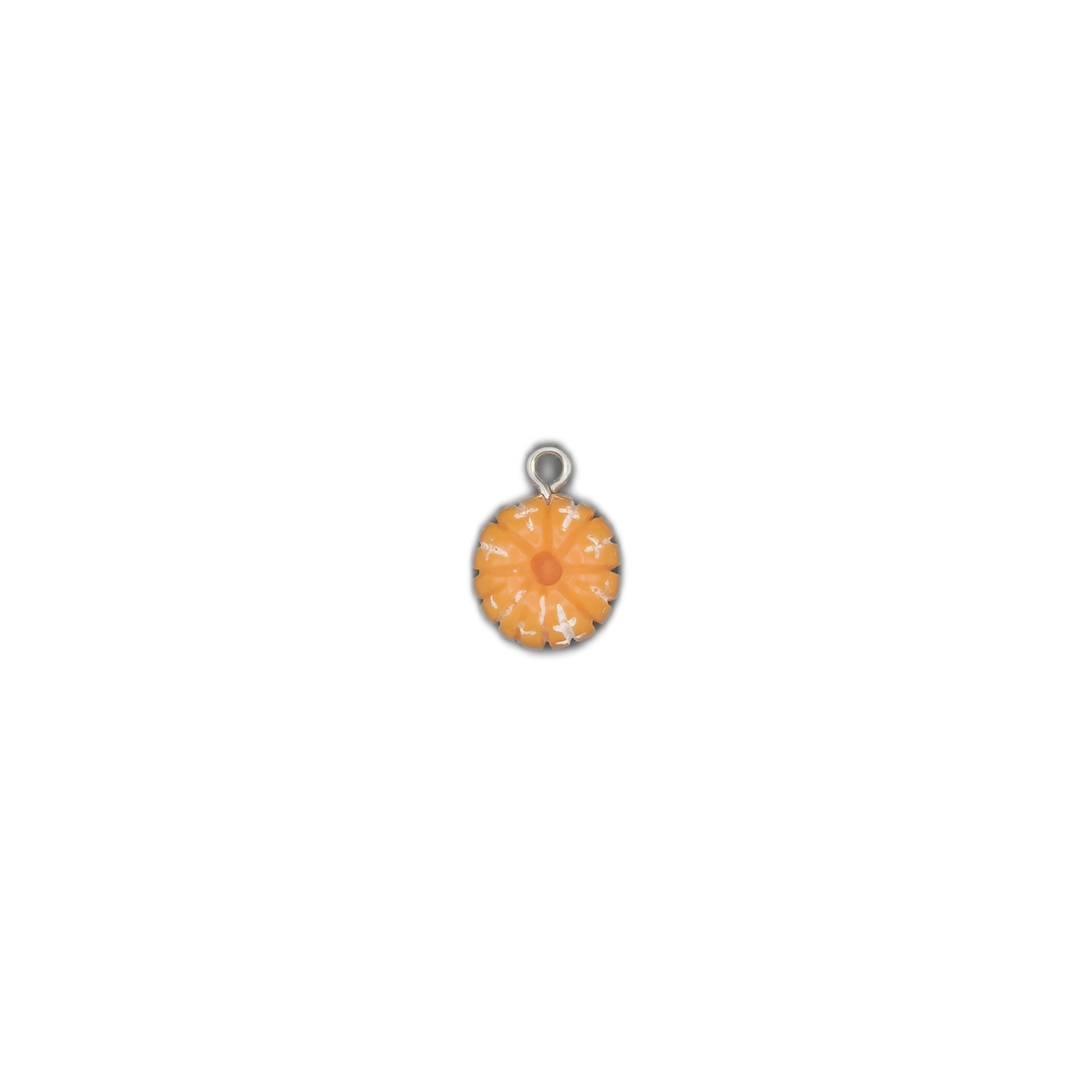 small round orange enamel flower charm centered on black background