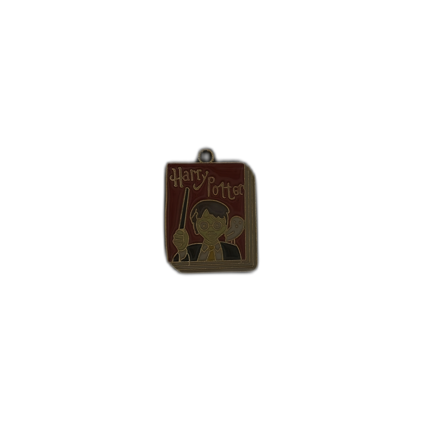 Full view of book-shaped enamel charm on black background showing 'Harry Potter' text with a boy holding a wand and an owl, red cover and gold outline.