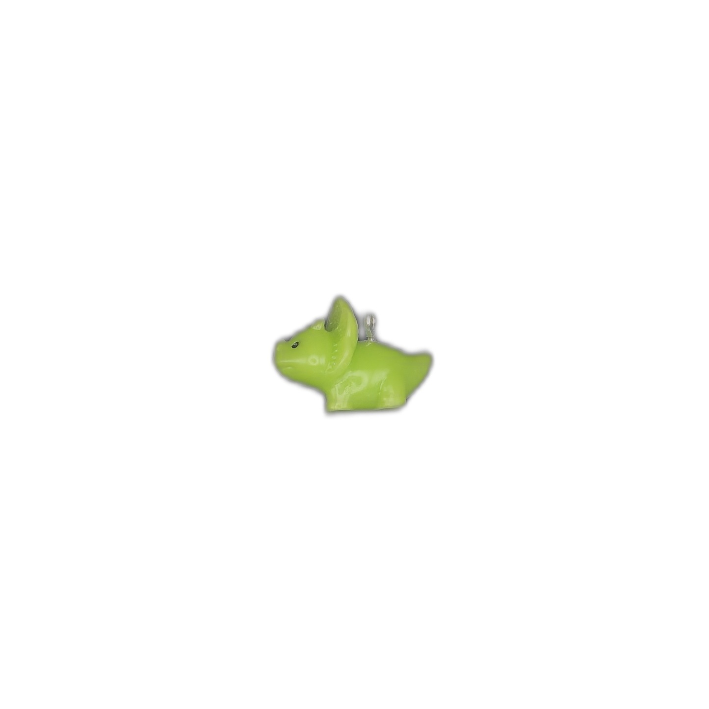 small green dinosaur-shaped charm centered on black background