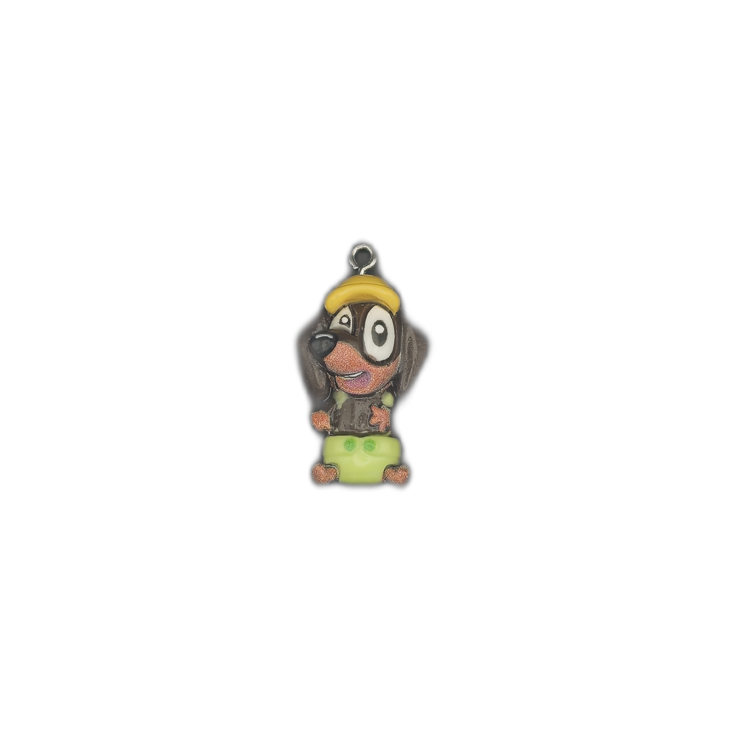 full view of small cartoon dog pendant charm centered on black background