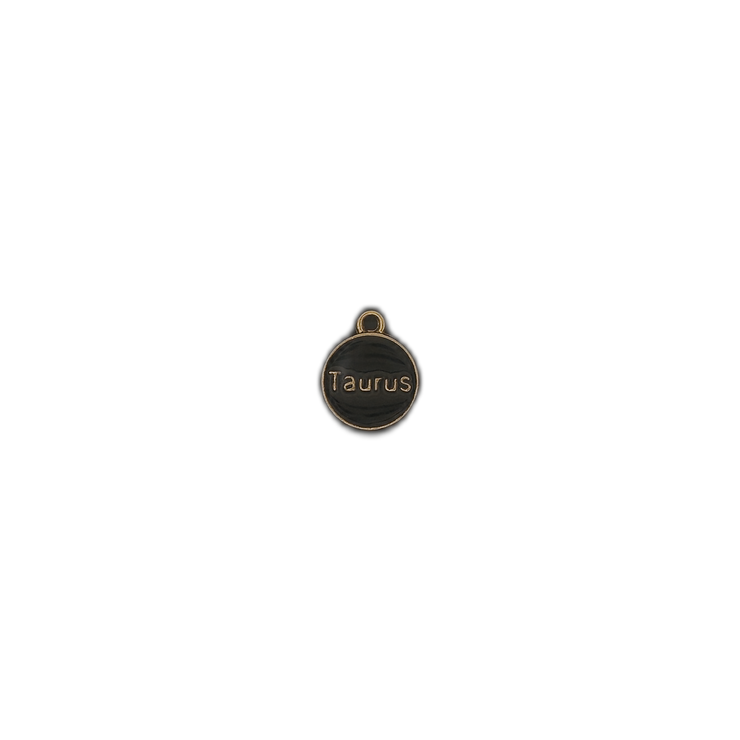 small round black and gold charm with the word Taurus
