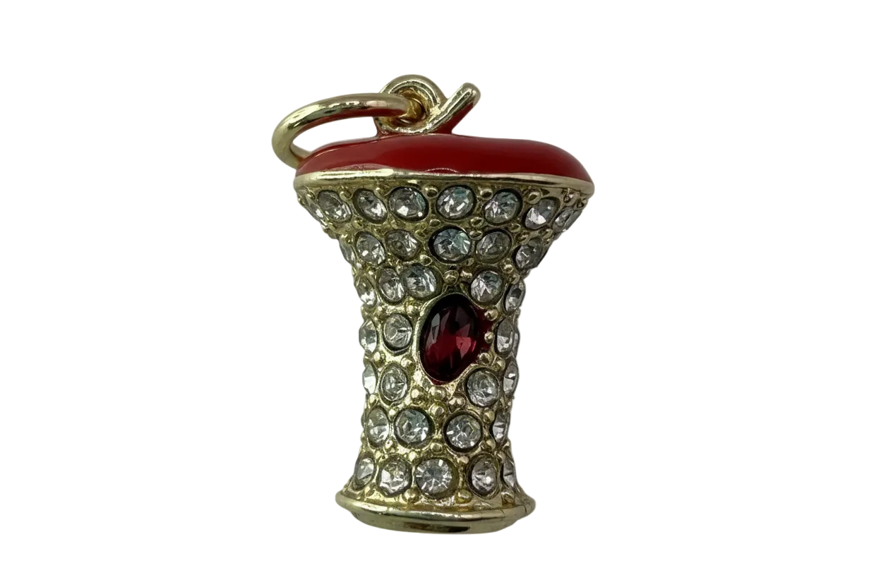 Gold mushroom charm with glossy red cap, clear crystals, and red oval gem accent