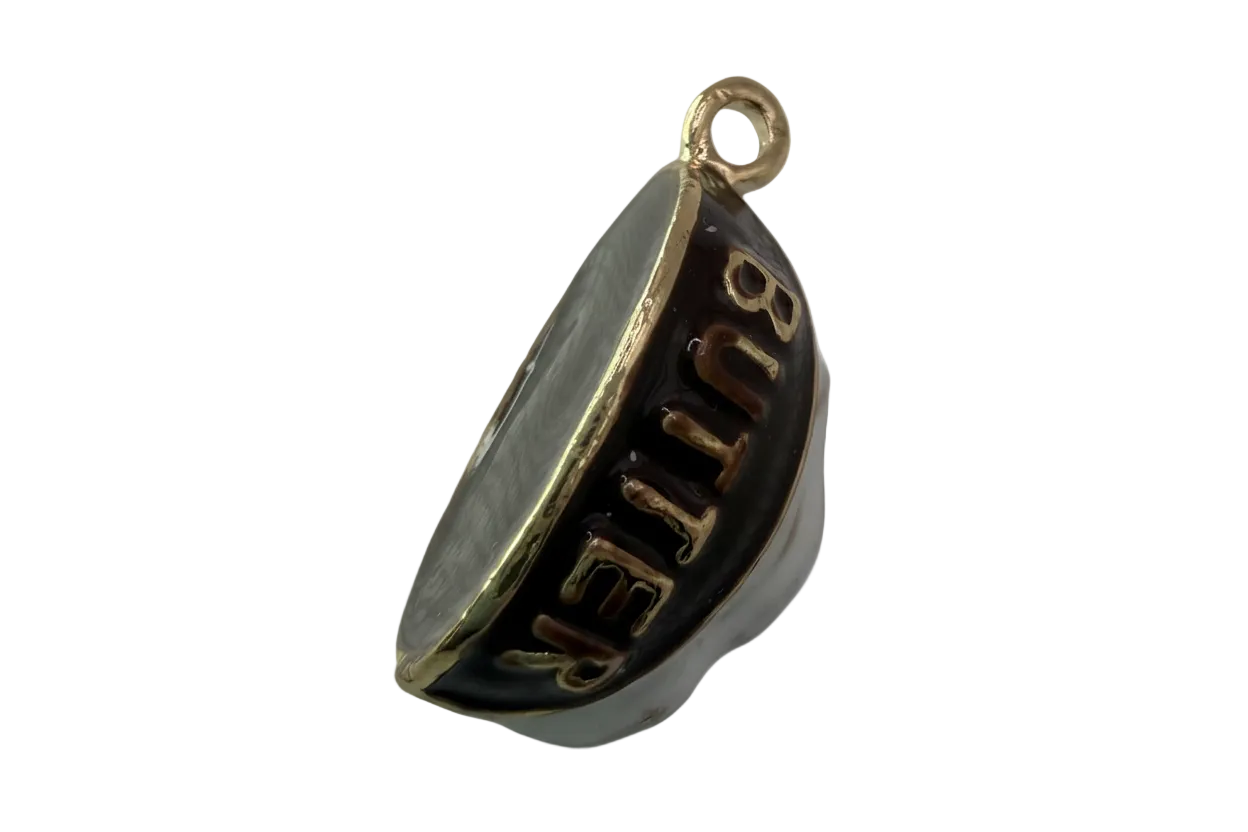Glossy black crescent with raised gold BUTTER lettering and polished gold trim