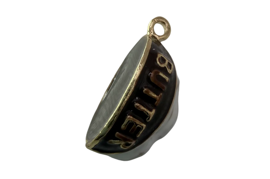 Glossy black crescent with raised gold BUTTER lettering and polished gold trim