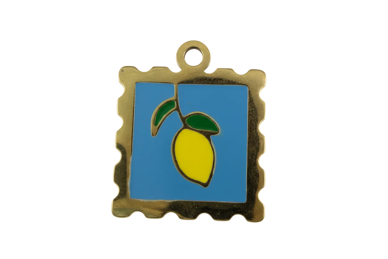 Gold stamp-style pendant with blue enamel background and yellow lemon with green leaves