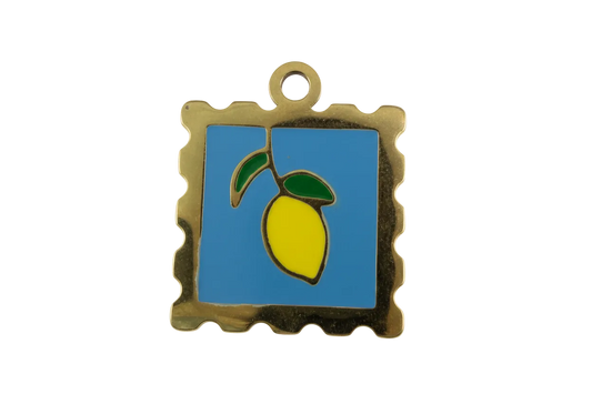 Gold stamp-style pendant with blue enamel background and yellow lemon with green leaves