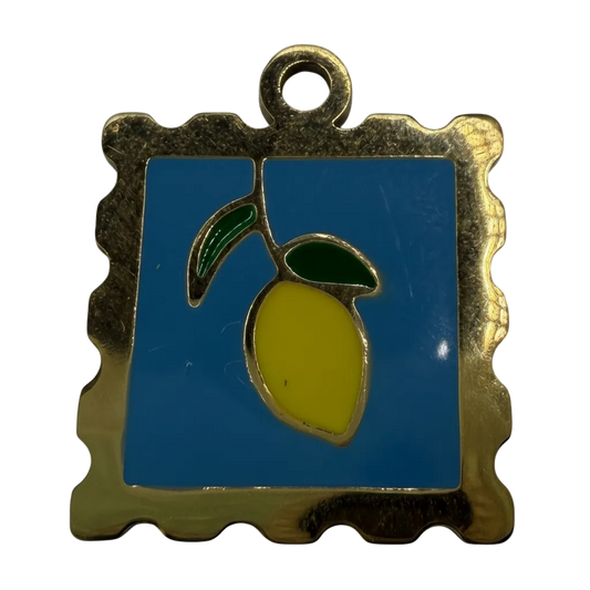 Gold-framed blue square enamel tile with yellow lemon and green leaves