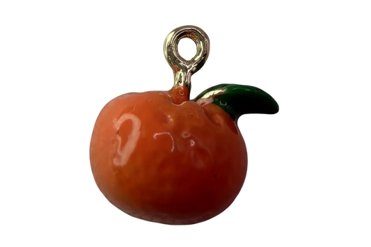Glossy orange citrus fruit charm with green leaf and polished gold details