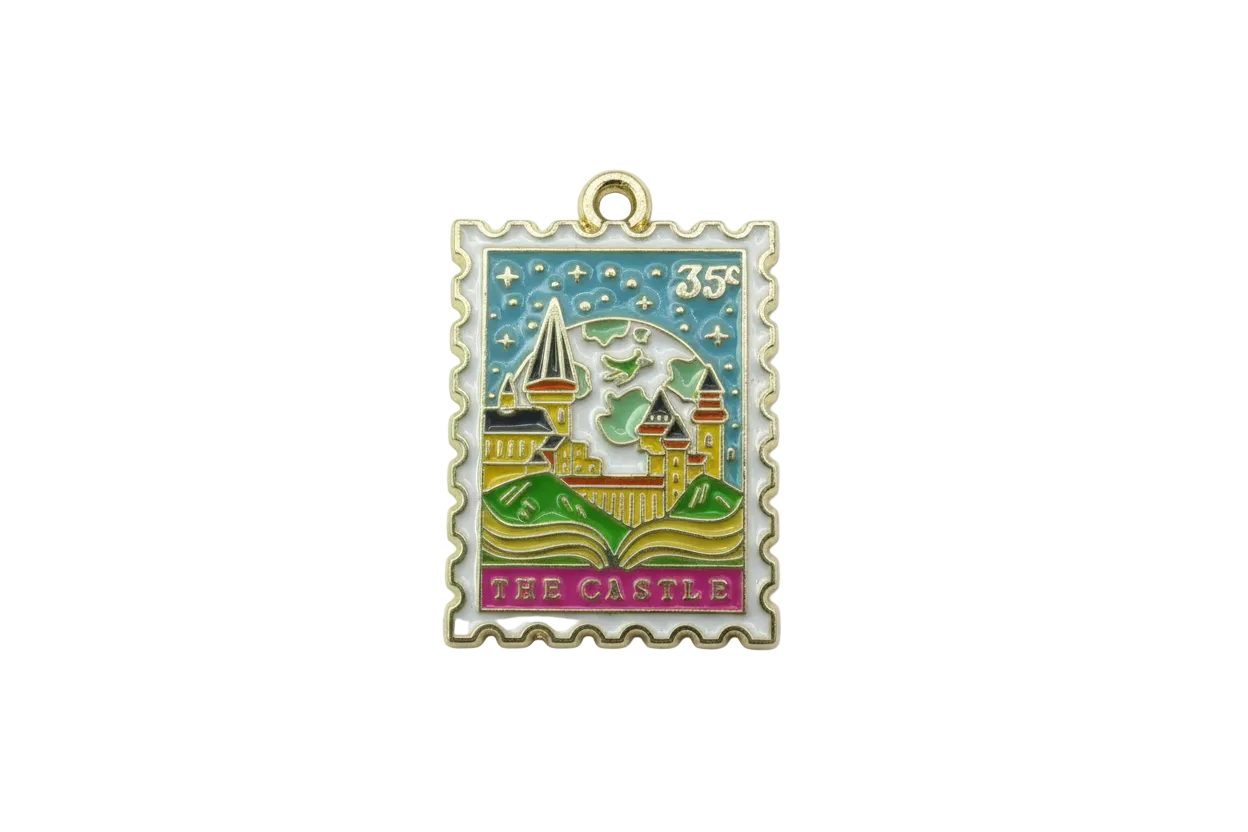 Gold-framed enamel postage stamp with castle scene, starry sky, 35¢ mark, and “THE CASTLE” text