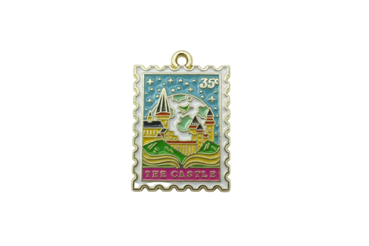 Gold-framed enamel postage stamp with castle scene, starry sky, 35¢ mark, and “THE CASTLE” text