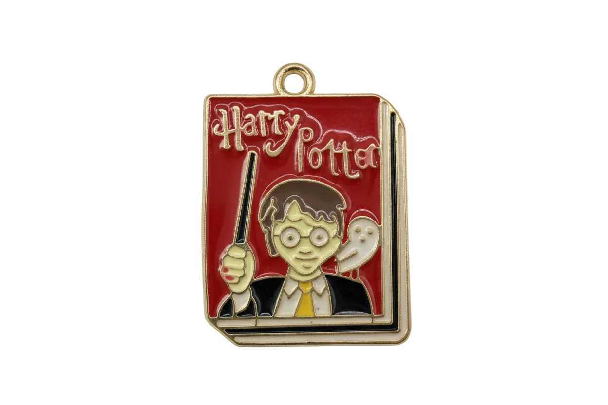 Red enamel book cover with gold lettering, young wizard with glasses holding a wand, and a white owl accent