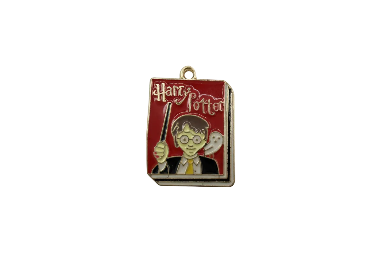 Red enamel wizard book cover with wand and owl accents