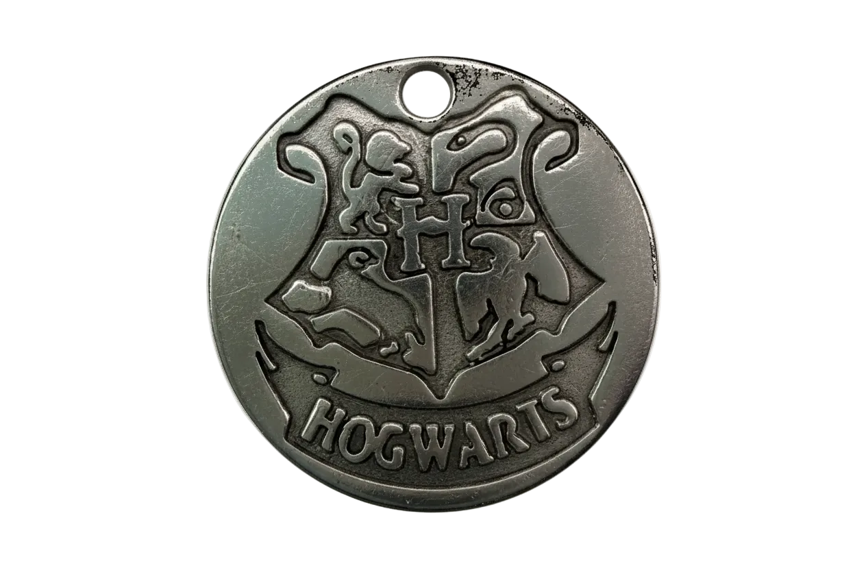 Round antique-silver medallion with raised school crest and banner engraving