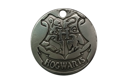 Round antique-silver medallion with raised school crest and banner engraving