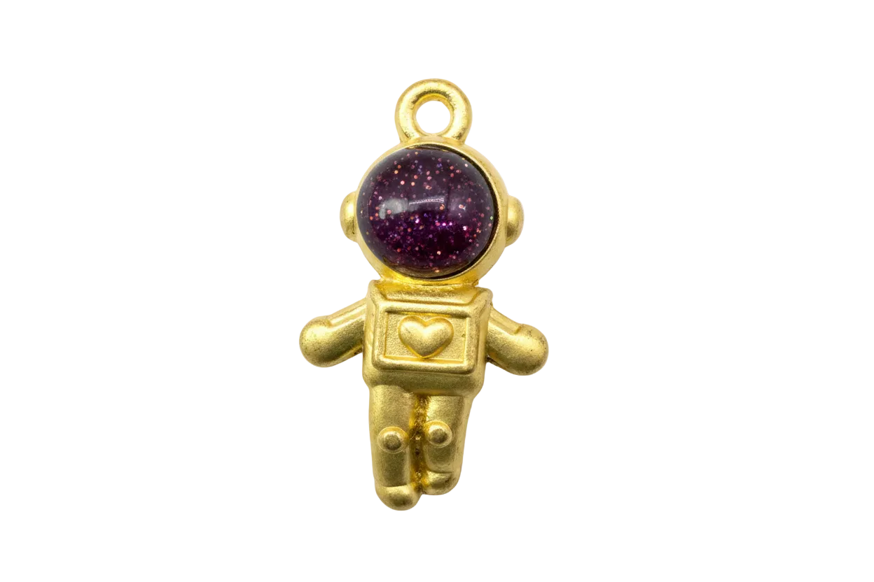 Gold astronaut charm with glossy burgundy glitter cabochon helmet and small heart chest detail