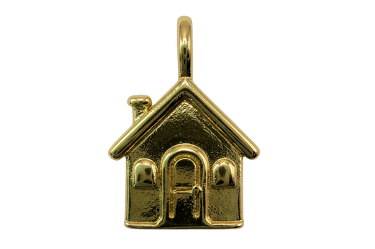 Gold house charm with pitched roof, chimney, arched door, and two windows