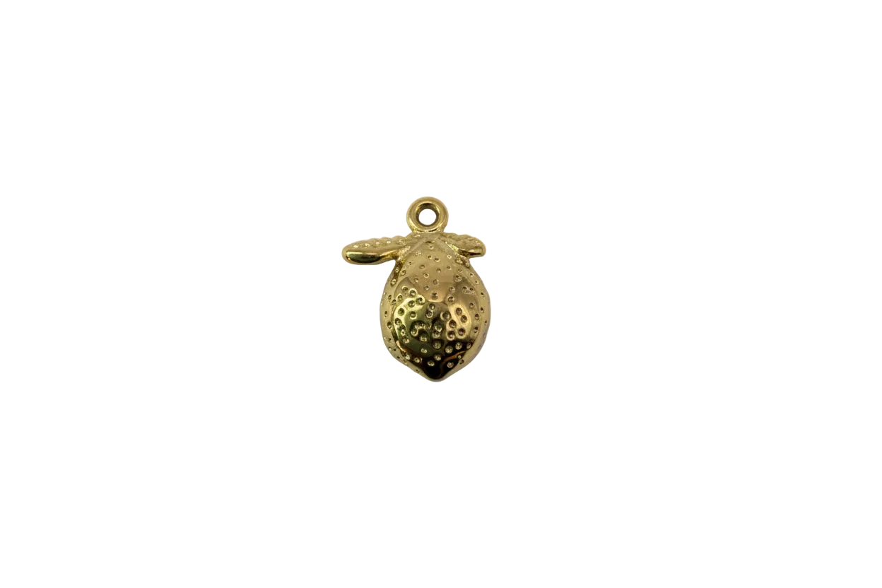Gold strawberry fruit with raised seed texture and leaf cap