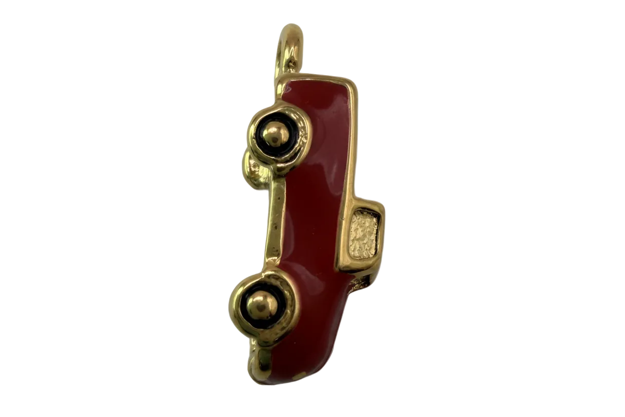 Glossy red classic car charm with gold trim and black wheels on black background