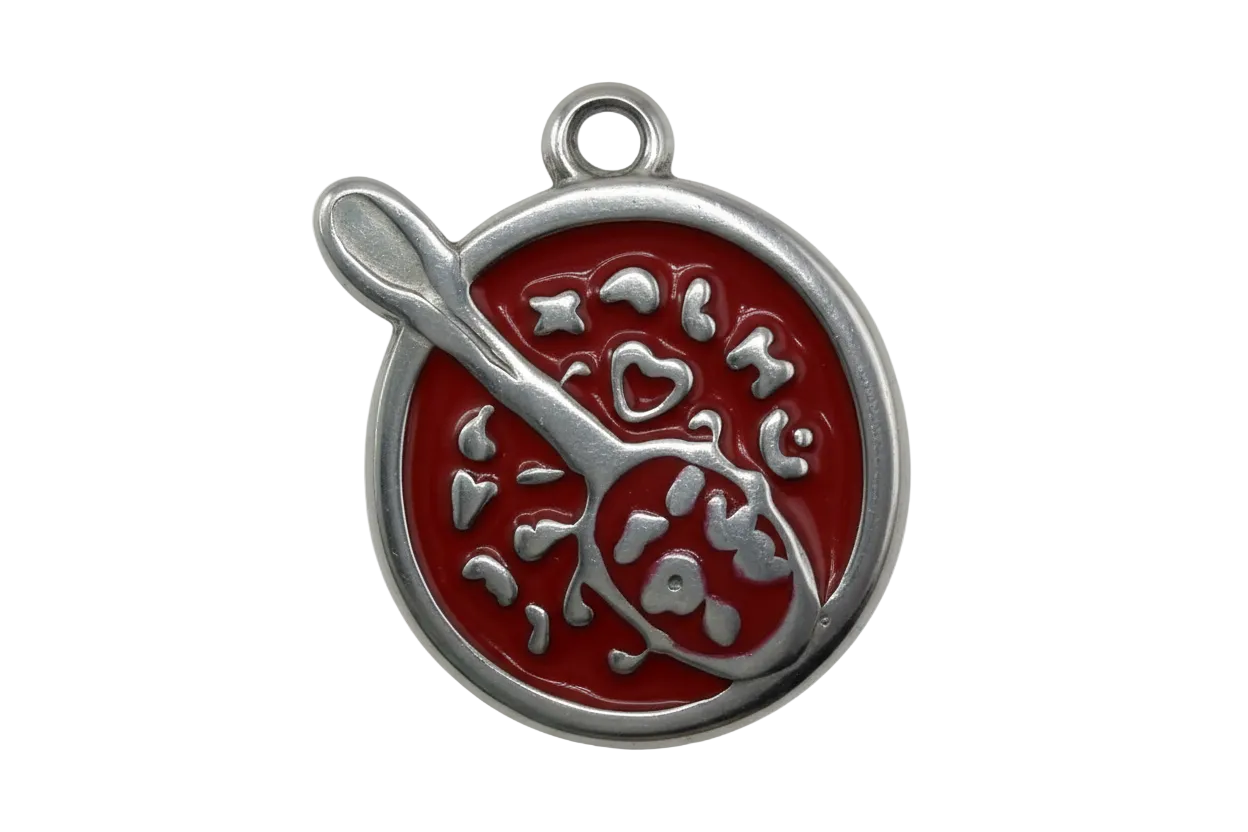 Red enamel soup bowl with spoon design and raised silver-tone details