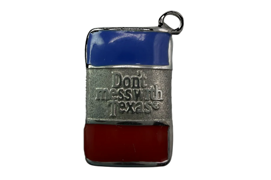 Rectangular silver tag with blue and red enamel stripes and raised “Don’t mess with Texas” lettering