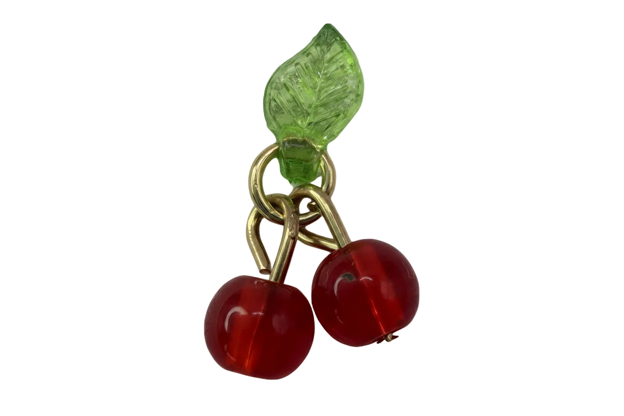 Translucent red cherry pair with green leaf detail and polished gold finish