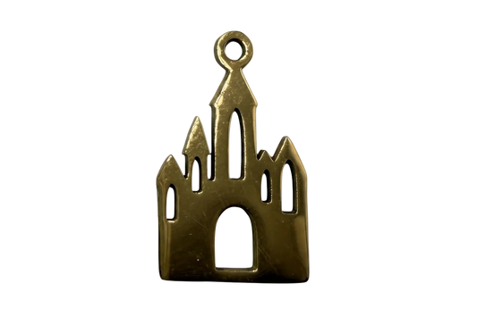 Gold gothic cathedral silhouette charm with arched window cutouts and tall spires