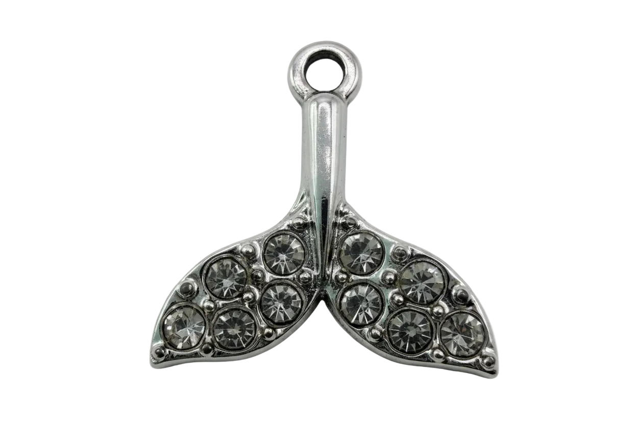 Silver whale tail charm with pavé clear crystals on a black background