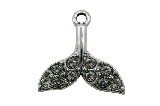 Silver whale tail charm with pavé clear crystals on a black background