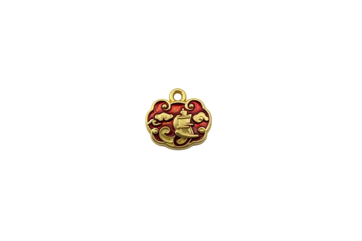 Gold cloud piece with crimson enamel sailing ship motif