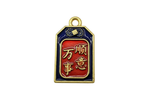 Gold-framed navy and red enamel amulet tag with raised script symbols