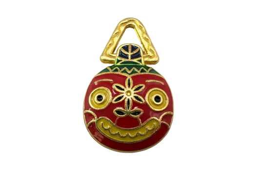 Red enamel folk mask with gold detailing, green accents, and yellow eyes