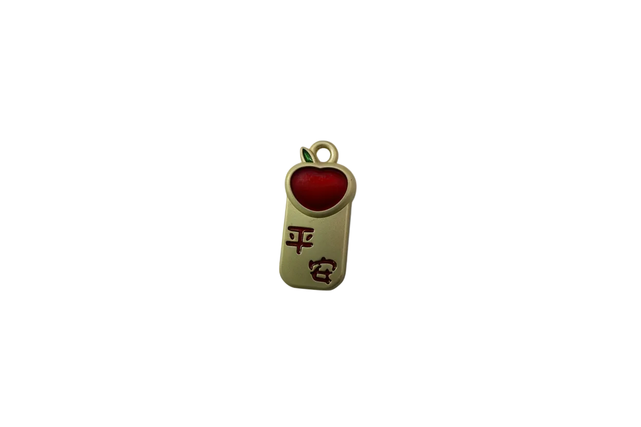 Gold tag with red heart apple, green leaf, and red script