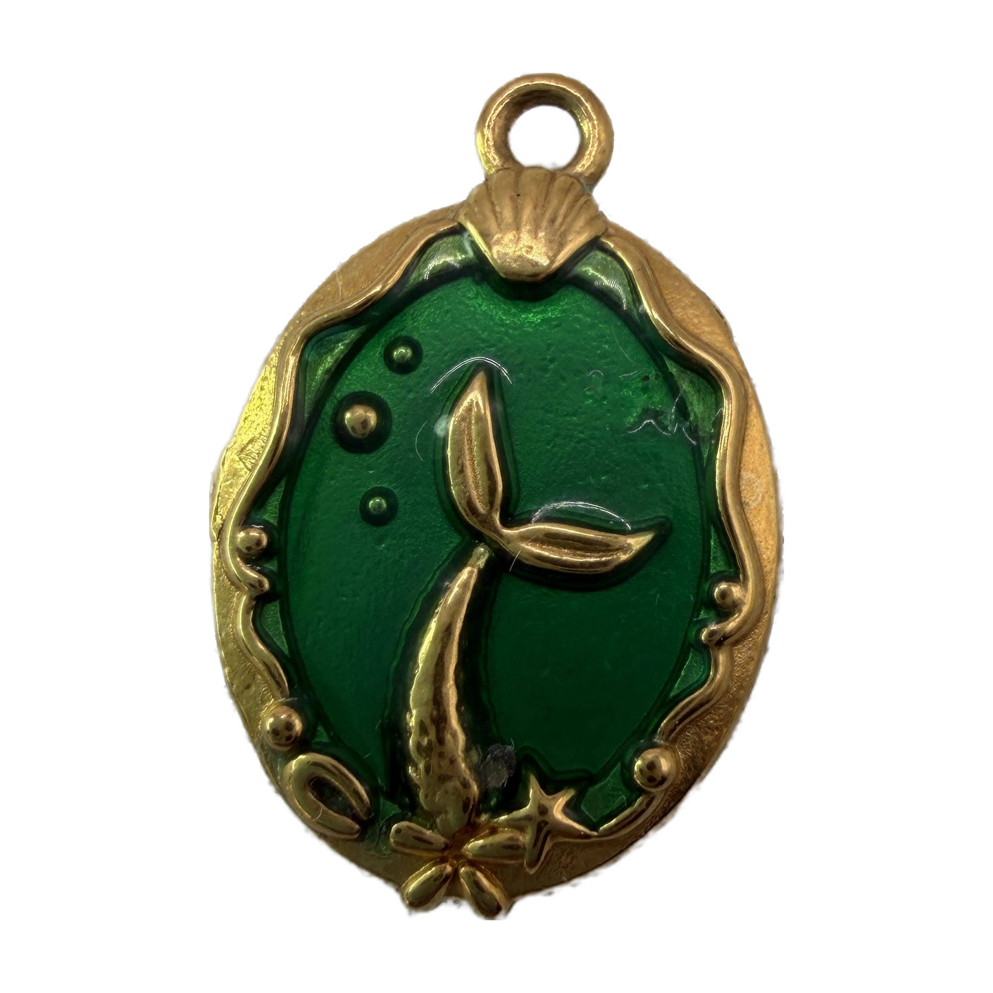 Oval gold medallion with emerald green enamel and raised mermaid tail, shell, and starfish details