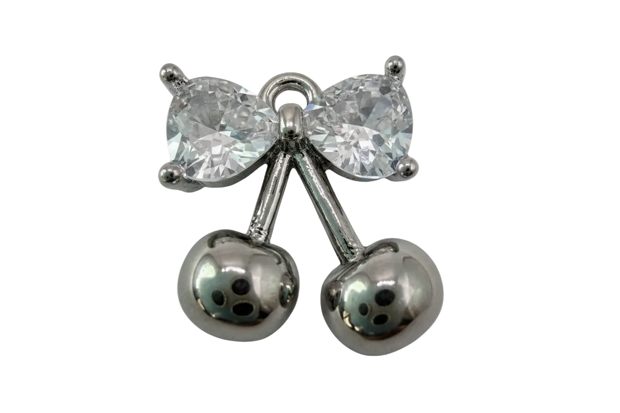 Polished silver cherry pair with faceted clear bow gem accent