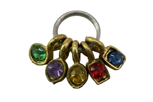 Gold multicolor gem cluster with green, purple, yellow, red, and blue stones on a silver ring