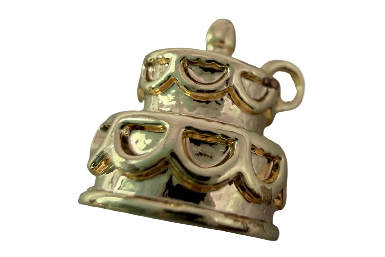 Tiered celebration cake charm in white enamel with glossy gold detailing